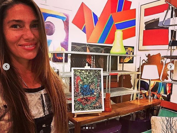 Heather Karlie Vieira at the Antique and Design Center during High Point Furniture Market with the 20th Century abstract shaped canvas by Canadian artist Reginald Holmes painitng